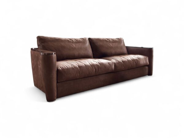 Classic leather designer sofa with rounded armrests and metallic accents