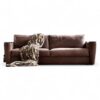 Modern three-seater sofa in brown leather with plush cushions