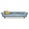 Stylish modern sofa with light blue upholstery and throw pillows