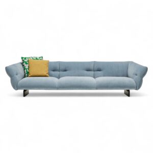 Stylish modern sofa with light blue upholstery and throw pillows