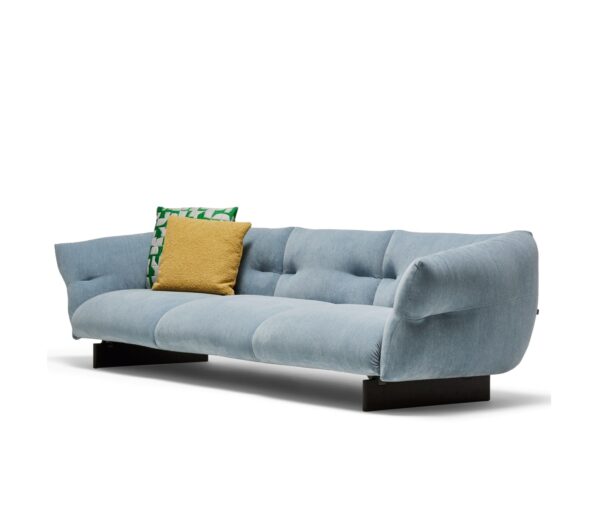 Stylish modern sofa with light blue upholstery and throw pillows