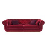 Luxurious burgundy velvet sofa with classic Chesterfield design and plush cushions