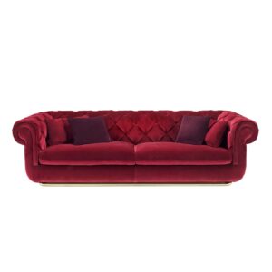 Luxurious burgundy velvet sofa with classic Chesterfield design and plush cushions