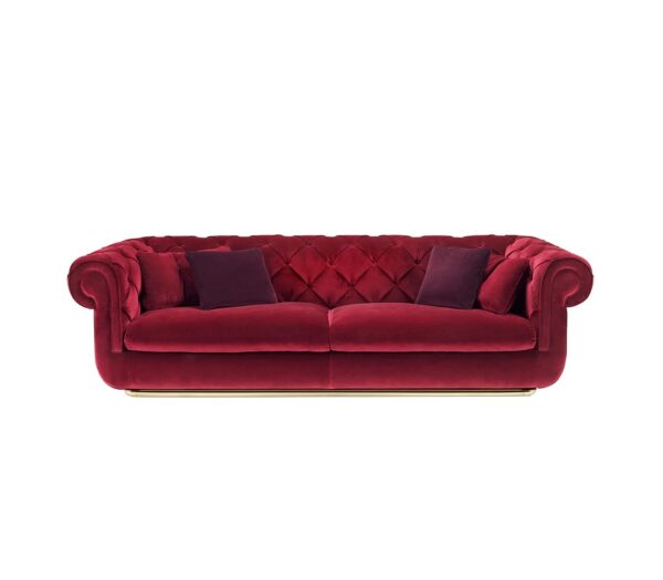 Luxurious burgundy velvet sofa with classic Chesterfield design and plush cushions