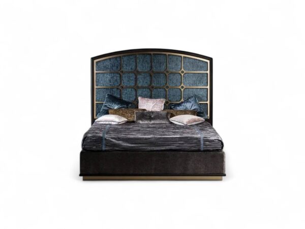 Grand designer bed with arched panels, detailed frame, and luxurious textured fabric
