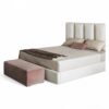 Cream upholstered bed with wide vertical panels and gold accents
