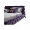 Modern tufted velvet bed with low-profile design.
