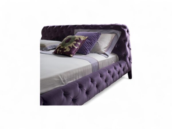 Modern tufted velvet bed with low-profile design.