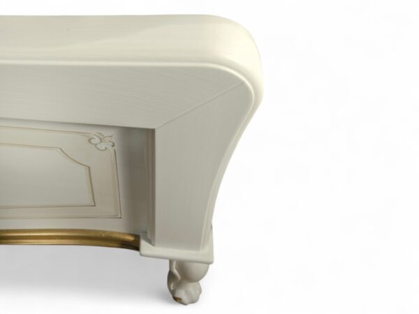Classic ornate bed with curved silhouette and gold accents