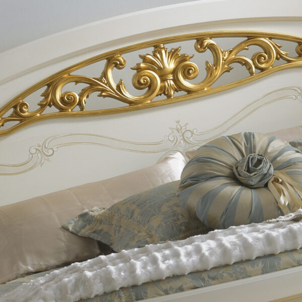 Classic ornate bed with curved silhouette and gold accents