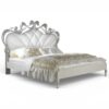 Luxury bed in pearl fabric with ornate silver carving details