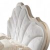 Regal bed with tufted ivory headboard and golden detailing
