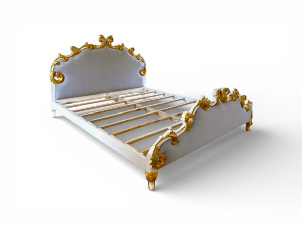 Traditional upholstered bed with stunning gold leaf accents and carved details