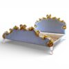 Gold-accented bed with tufted fabric and carved wooden frame