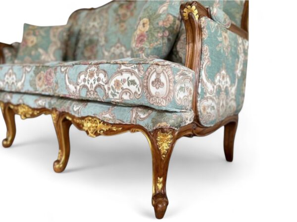 Antique-style Louis XV carved sofa with plush cushions and ornate frame