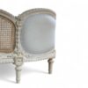 Vintage-inspired bed with French carving details and neutral upholstery
