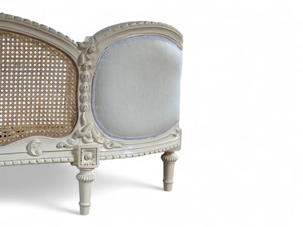Vintage-inspired bed with French carving details and neutral upholstery