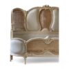 Elegant French bed with soft fabric upholstery and detailed wooden frame
