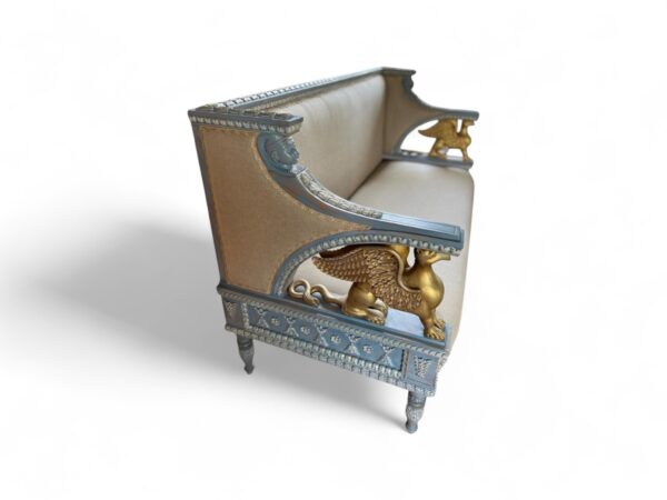 Elegant settee with hand-carved wood and classical motifs