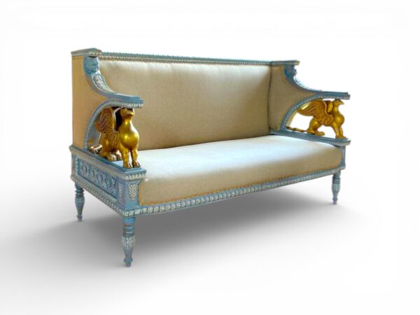 Neutral upholstered settee with golden griffins and decorative legs