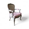 Ornate wooden chair with upholstered seat and antique charm