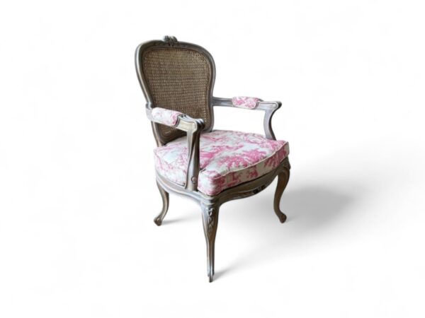 Ornate wooden chair with upholstered seat and antique charm