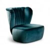 Teal velvet armchair with rounded base and elegant silhouette