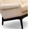 Cream boucle armchair and ottoman with sculpted wooden base