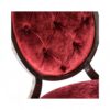Red velvet dining chair with button-tufted back and wooden frame