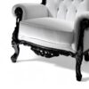 Ornate black wood armchair with white leather upholstery