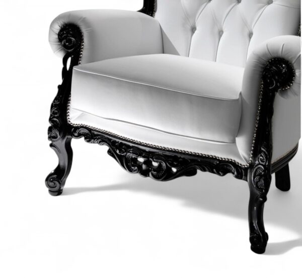 Ornate black wood armchair with white leather upholstery