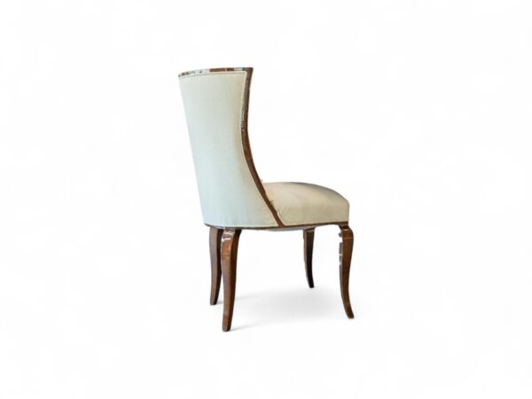 Elegant high-back dining chair with soft upholstery and sleek wood