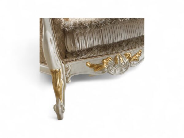 Opulent accent chair with gold leaf detailing and rolled arms