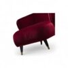 Tufted back velvet armchair with elegant black legs and brass tips