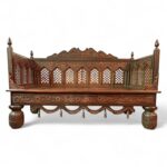 Traditional wooden divan with detailed hand-carved patterns