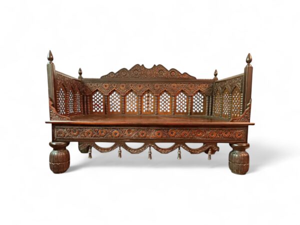 Traditional wooden divan with detailed hand-carved patterns