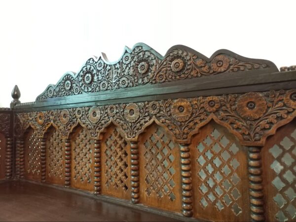 Heritage Wooden Divan with intricate lattice backrest and ornate carvings