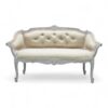 Classic carved loveseat with neutral fabric upholstery and tufted backrest