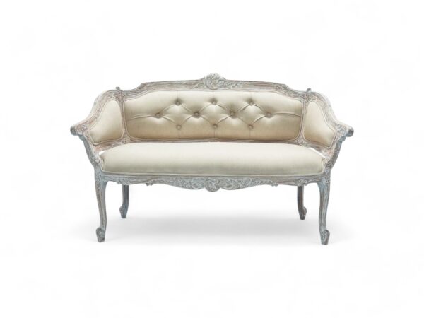Classic carved loveseat with neutral fabric upholstery and tufted backrest