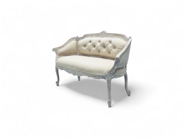 Vintage-style loveseat with luxurious upholstery and detailed woodwork