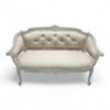 Elegant loveseat with soft neutral fabric and carved wooden frame