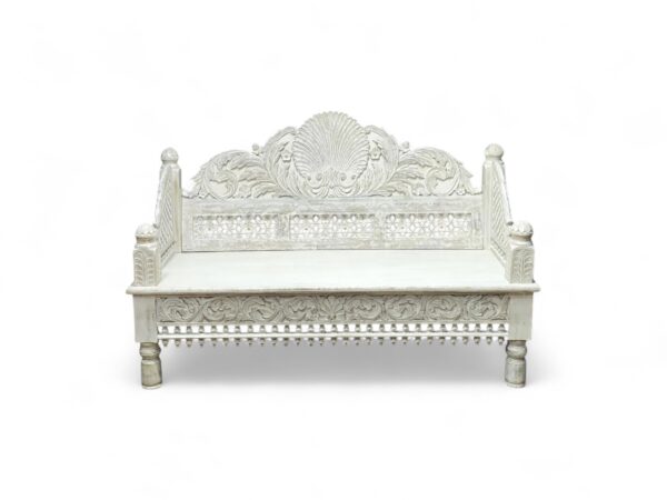 Luxurious hand-carved daybed with white finish, ideal for royal-inspired interiors
