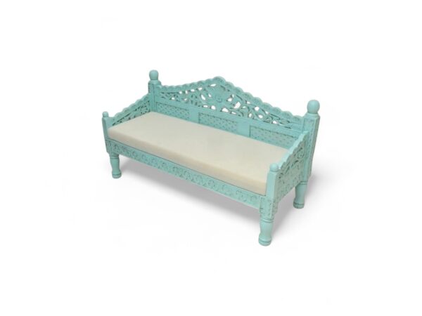 Handcrafted wooden settee with detailed carvings and neutral cushion