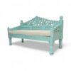 Bohemian-inspired settee featuring floral design and light green paint