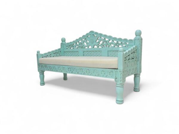 Bohemian-inspired settee featuring floral design and light green paint