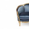 Antique-style French sofa with ornate wooden frame and plush velvet