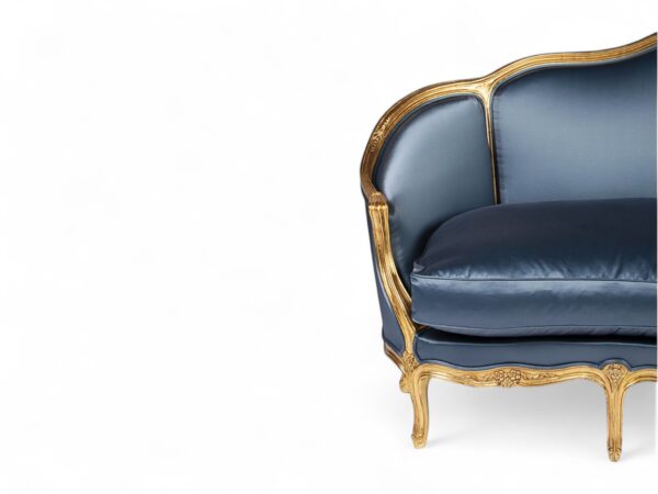Antique-style French sofa with ornate wooden frame and plush velvet