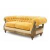 Elegant vintage sofa in rich yellow velvet with traditional tufting