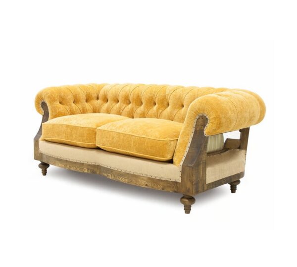 Elegant vintage sofa in rich yellow velvet with traditional tufting
