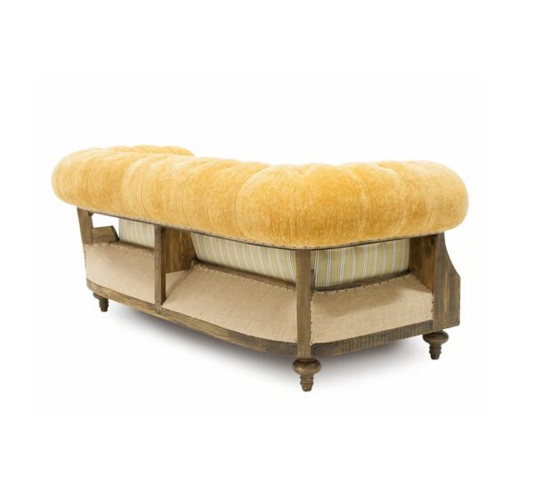 Classic Chesterfield sofa featuring plush velvet cushions and rolled arms